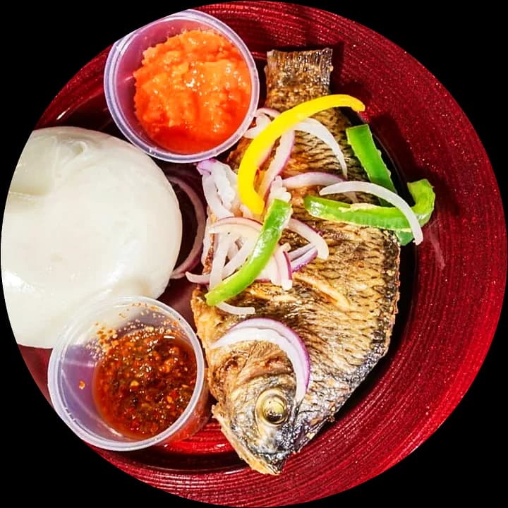 Banku with grilled tilapia, pepper and shito, from above